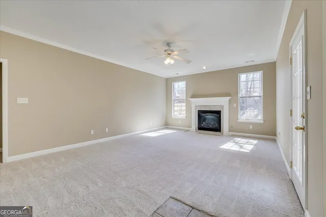 en empty room with windows and a fireplace