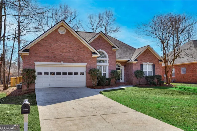a sign board with yard and green space