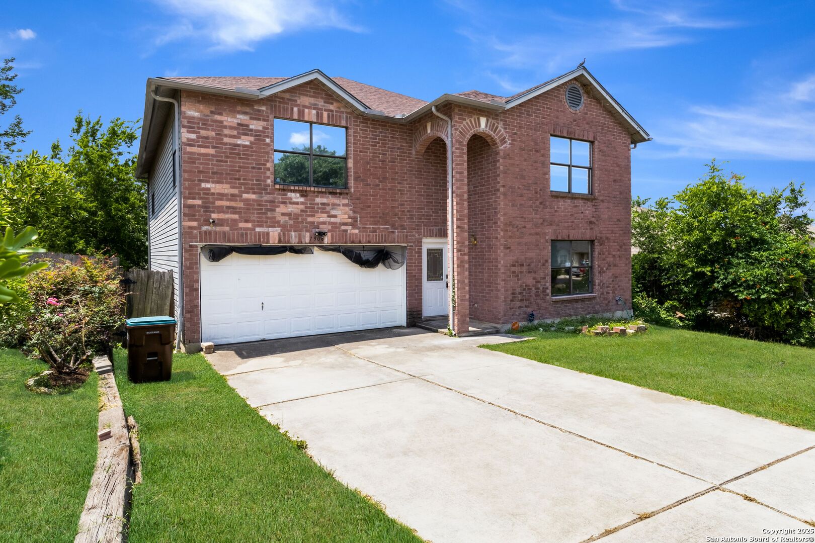 a front view of a house with a yard and garage