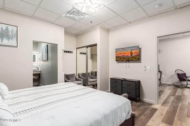 a bedroom with a bed and a chandelier