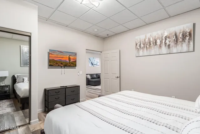 a bedroom with a bed and a flat screen tv