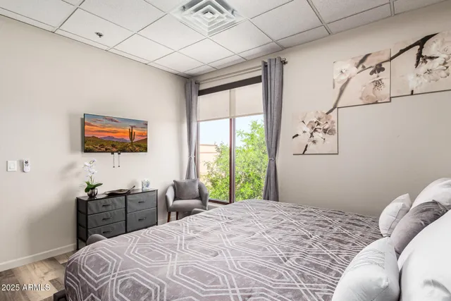 a bedroom with a bed and a flat screen tv