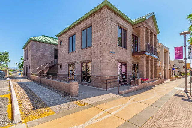 a view of a house with barbeque and sitting area