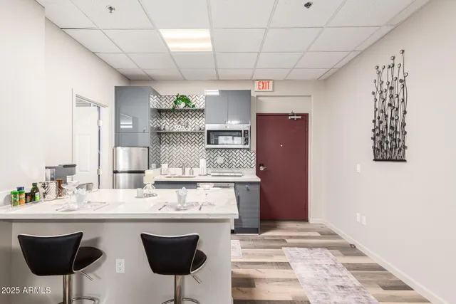 a kitchen with stainless steel appliances granite countertop a sink and a refrigerator
