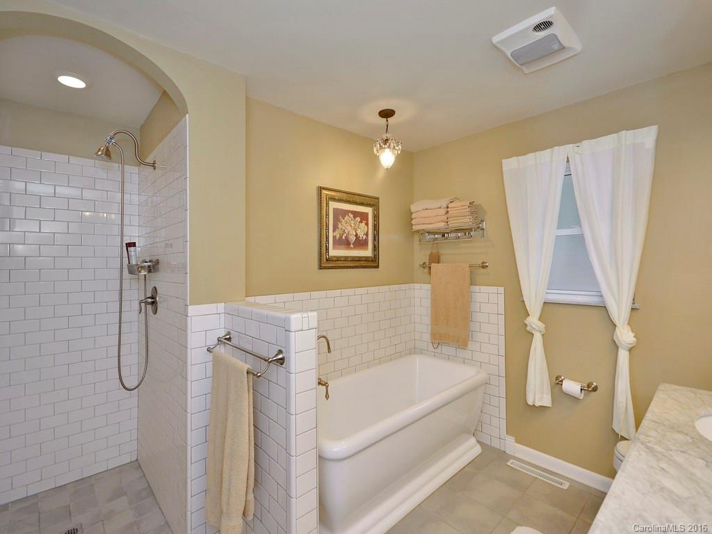 43 Cold Springs Road Hendersonville, NC 28792 - Photo 15 of 24 a bathroom with a tub sink and shower