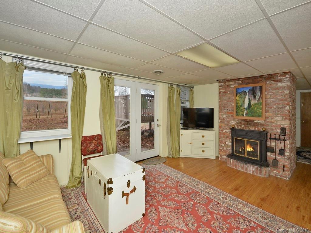 43 Cold Springs Road Hendersonville, NC 28792 - Photo 17 of 24 a living room with furniture a flat screen tv and a fireplace