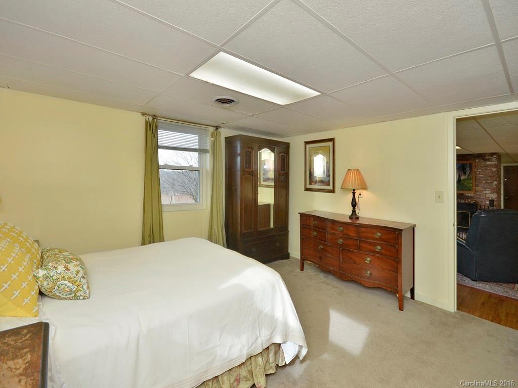 43 Cold Springs Road Hendersonville, NC 28792 - Photo 20 of 24 a bedroom with a bed and dresser with mirror