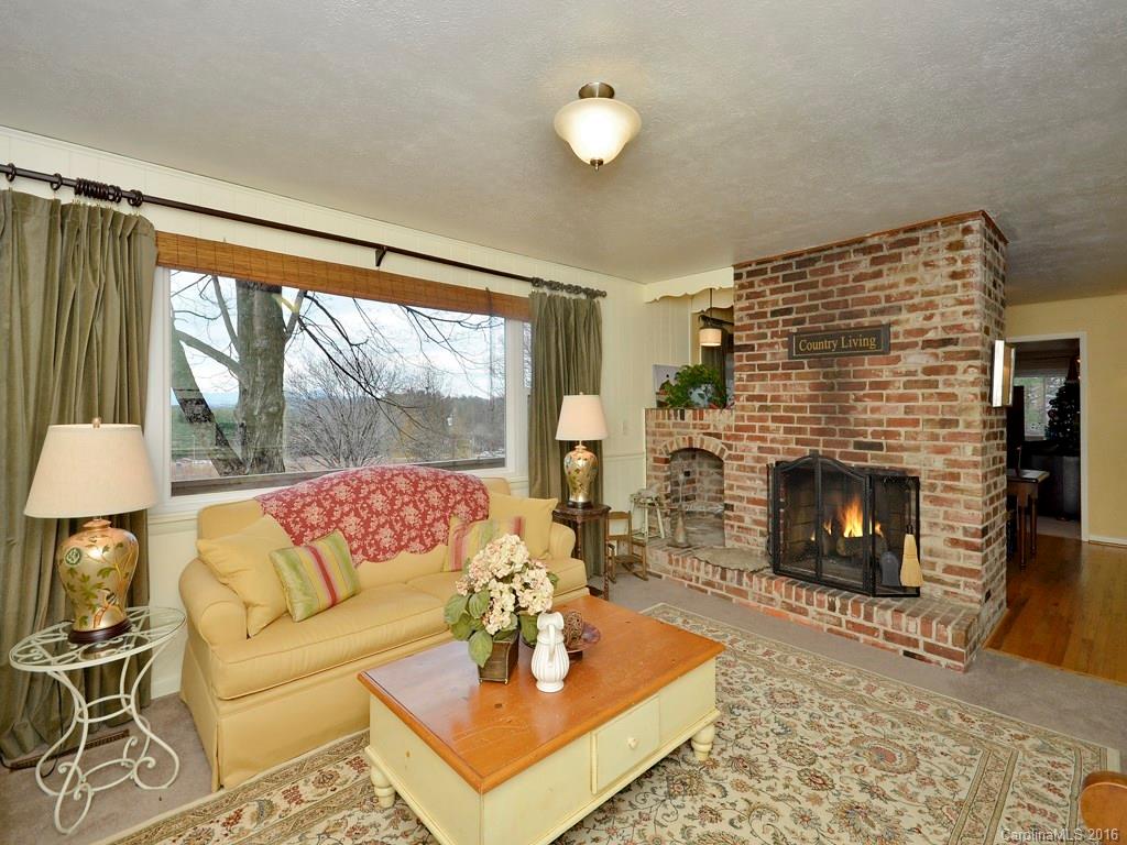 43 Cold Springs Road Hendersonville, NC 28792 - Photo 3 of 24 a living room with furniture a fireplace and a large window
