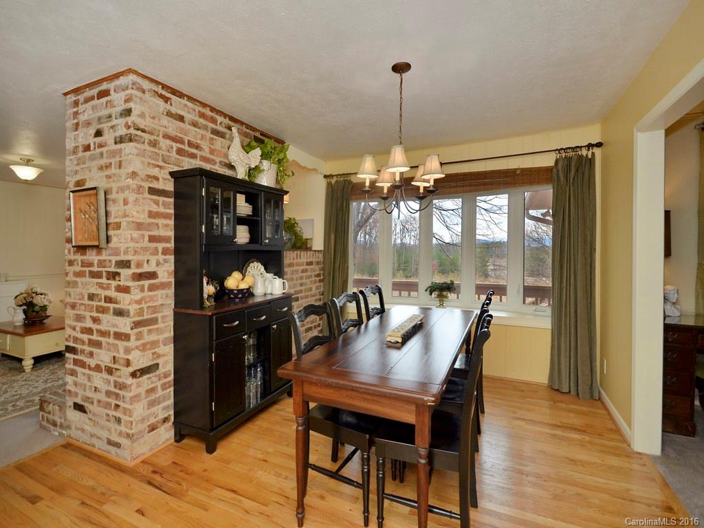 43 Cold Springs Road Hendersonville, NC 28792 - Photo 4 of 24 a dining room with furniture a chandelier and wooden floor