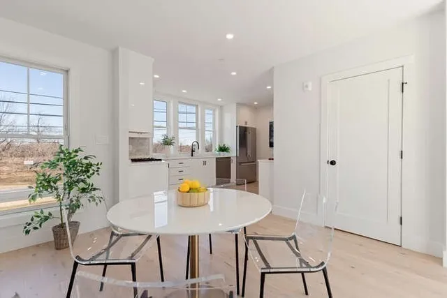a view of a dining room with a table and chairs