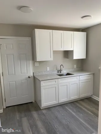 a kitchen with granite countertop white cabinets and white appliances