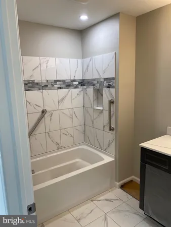 a bathroom with a bathtub and shower