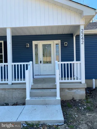 a view of front door of house with stairs