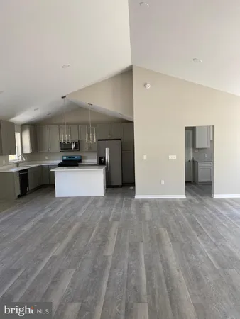 a view of a kitchen with a sink and a refrigerator