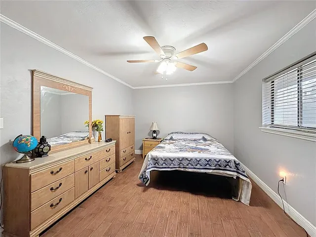 a spacious bedroom with a bed and a dresser