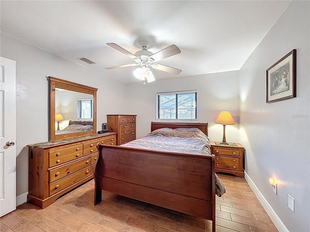 209 1st Street Tavares, FL 32778 - Photo 13 of 21 a bedroom with a bed and a chandelier