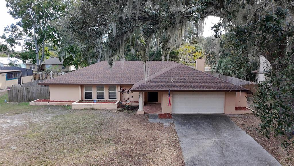209 1st Street Tavares, FL 32778 - Photo 3 of 21 a house view with a garden space