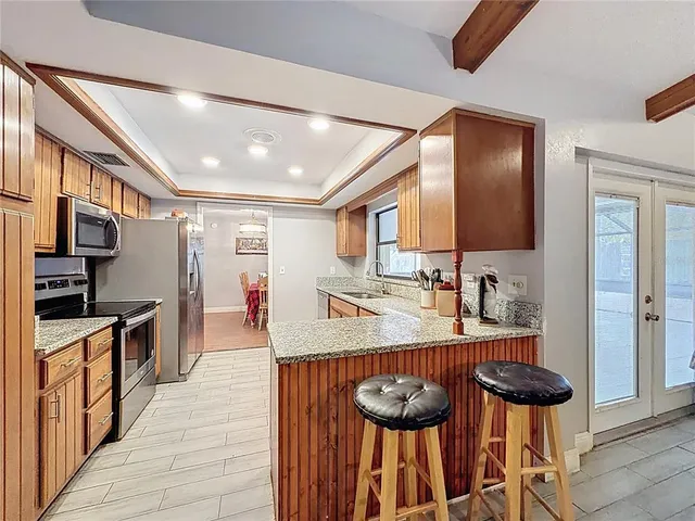 a kitchen with granite countertop lots of counter top space and stainless steel appliances