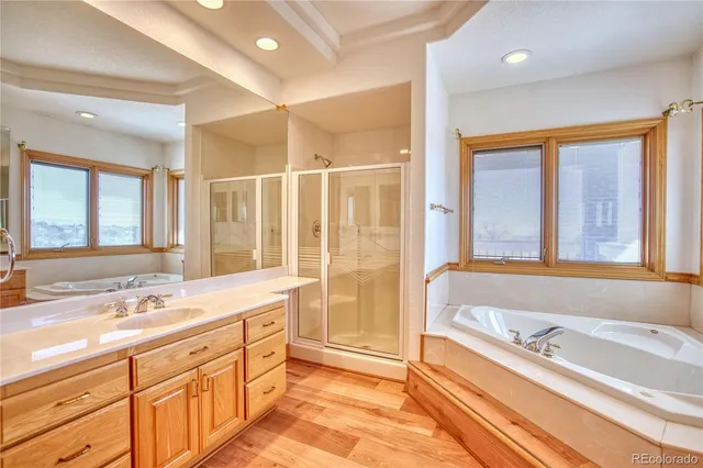 a bathroom with a tub sink and double vanity