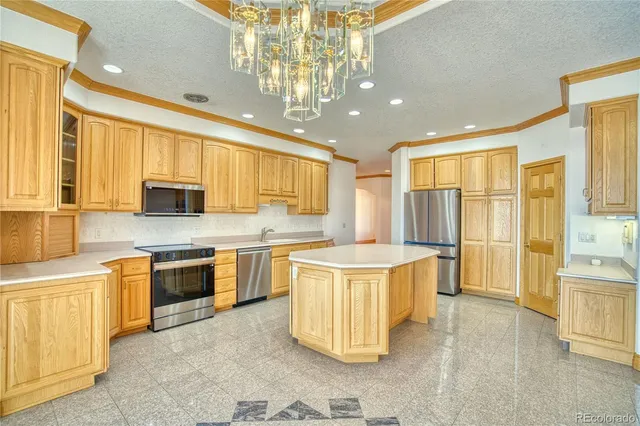 a large kitchen with stainless steel appliances granite countertop a sink and cabinets
