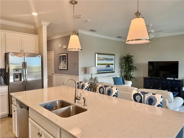 a kitchen with a sink a counter and windows