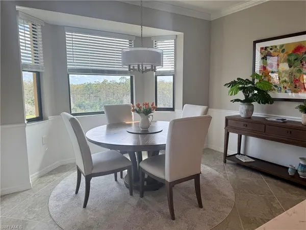 a dining room with furniture and window
