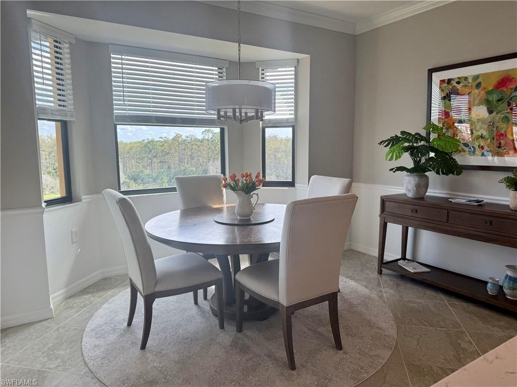 9584 Trevi Court, Unit 5242 Naples, FL 34113 - Photo 13 of 50 a dining room with furniture and window