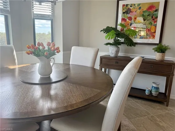 a view of a dining room with furniture and a potted plant