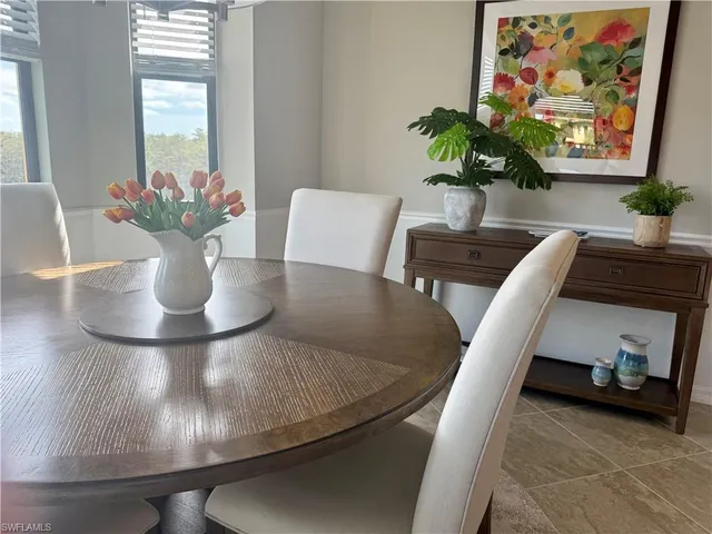 a view of a dining room with furniture and a potted plant