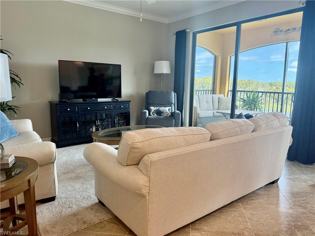 9584 Trevi Court, Unit 5242 Naples, FL 34113 - Photo 16 of 50 a living room with furniture and a flat screen tv