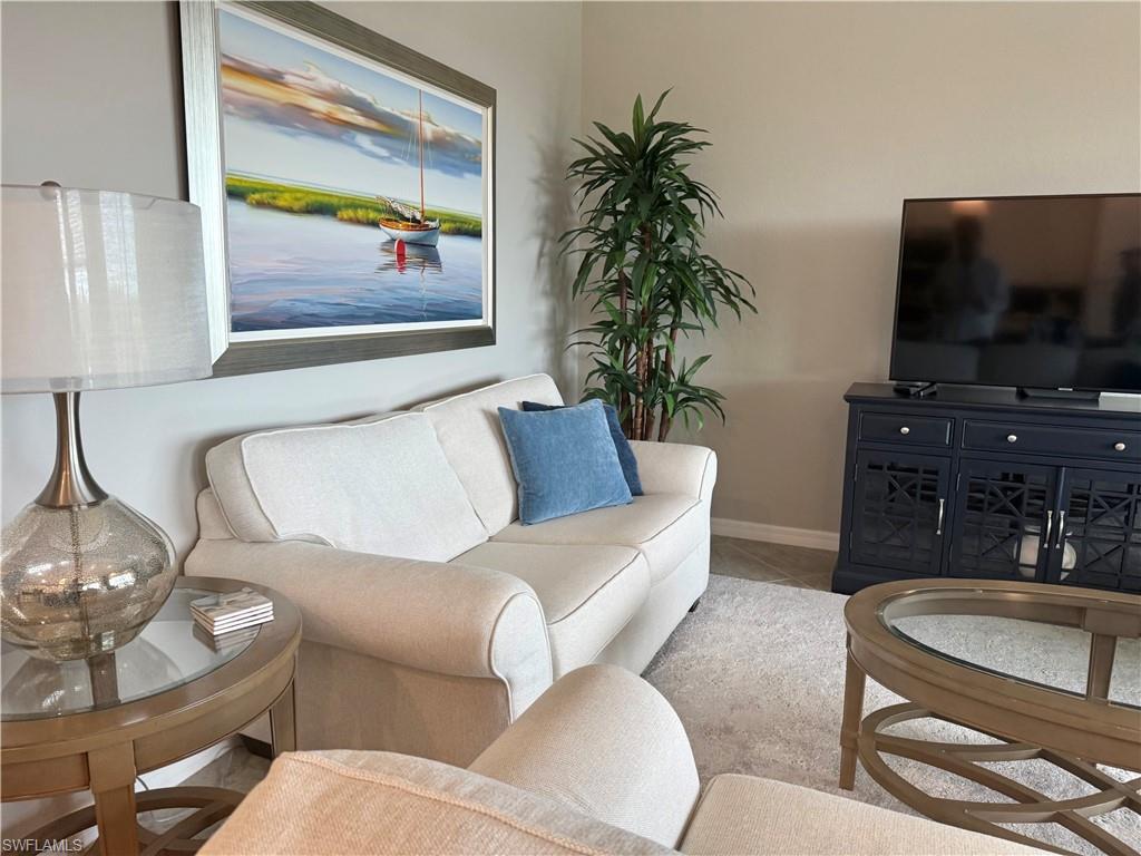 9584 Trevi Court, Unit 5242 Naples, FL 34113 - Photo 17 of 50 a living room with furniture and a flat screen tv