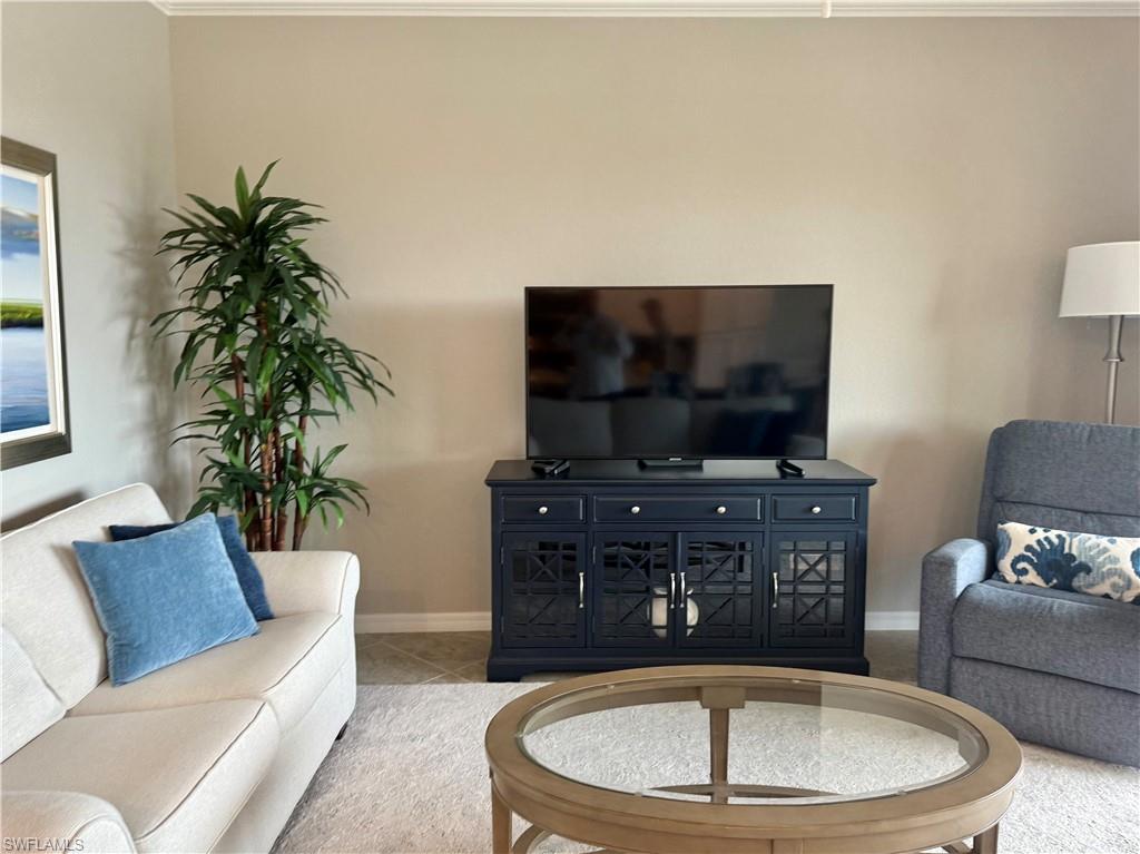 9584 Trevi Court, Unit 5242 Naples, FL 34113 - Photo 18 of 50 a living room with furniture and a flat screen tv