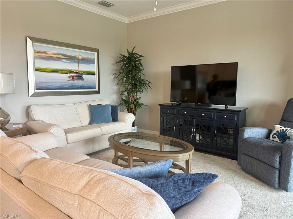9584 Trevi Court, Unit 5242 Naples, FL 34113 - Photo 19 of 50 a living room with furniture and a flat screen tv
