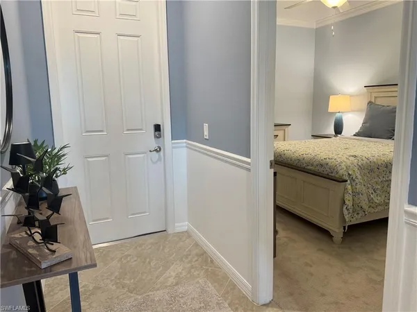 a bedroom with a bed and a potted plant