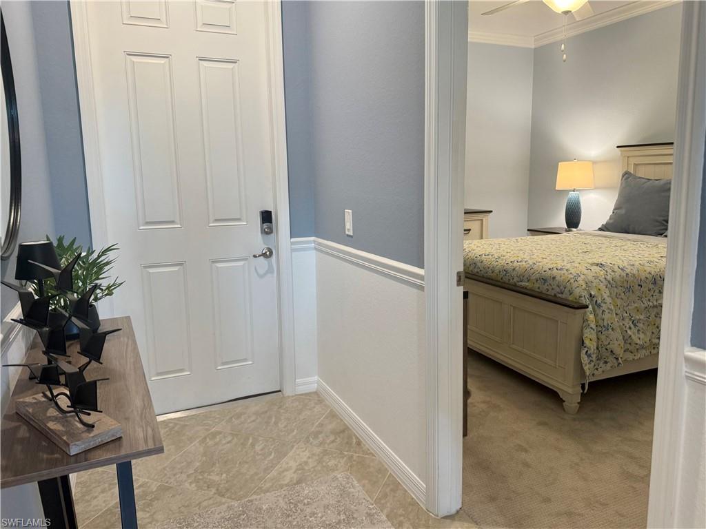 9584 Trevi Court, Unit 5242 Naples, FL 34113 - Photo 26 of 50 a bedroom with a bed and a potted plant