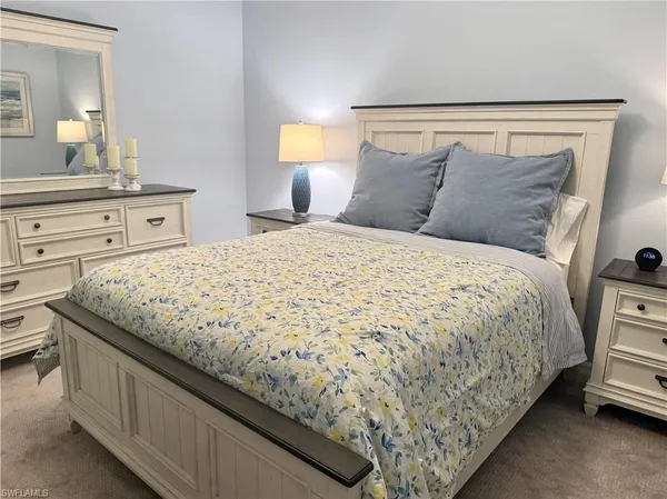 a bedroom with a bed and a night stand