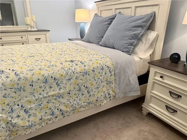 a bedroom with a bed and a dresser