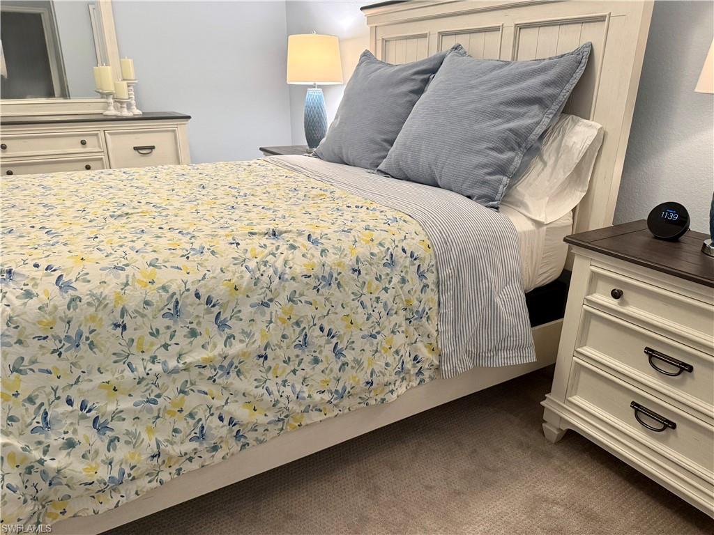 9584 Trevi Court, Unit 5242 Naples, FL 34113 - Photo 30 of 50 a bedroom with a bed and a dresser