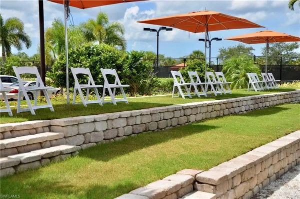a view of a chair and tables under an umbrella