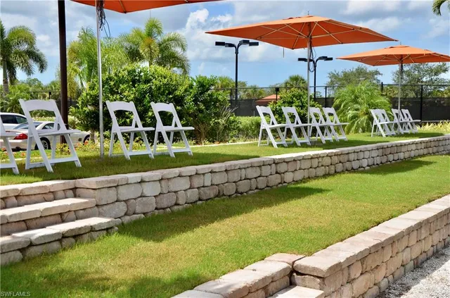 a view of a chair and tables under an umbrella
