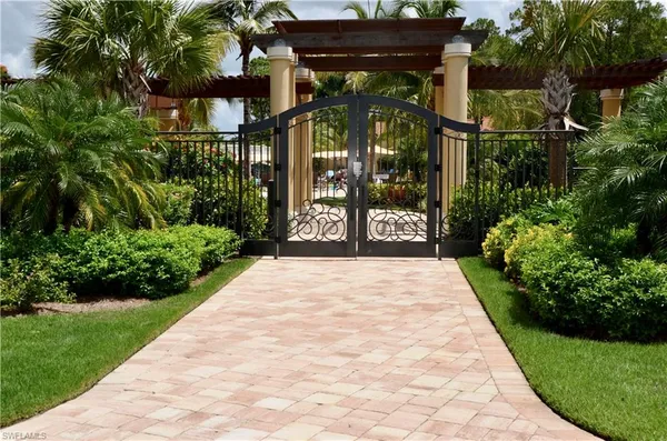 a view of a pathway of a house with a garden