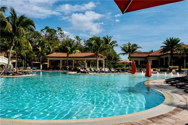 a swimming pool view with a seating space