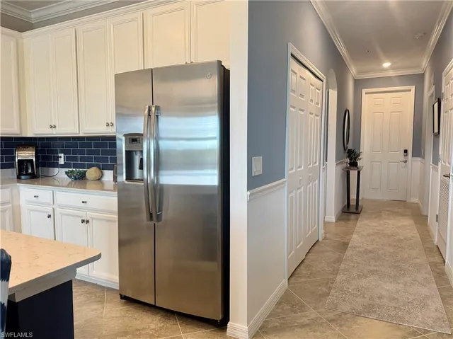 a kitchen with stainless steel appliances granite countertop a refrigerator and a stove