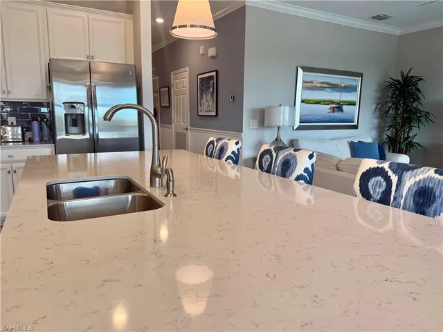 a kitchen with a stove a sink and a cabinets