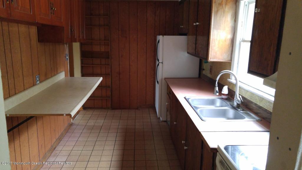 222 Newman Springs Road Red Bank, NJ 07701 - Photo 5 of 12 a kitchen with a sink and a refrigerator