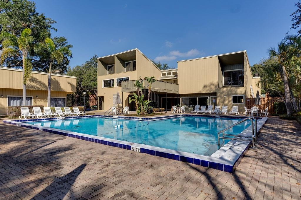 970 East Michigan Street, Unit B Orlando, FL 32806 - Photo 20 of 24 a view of a house with pool and chairs