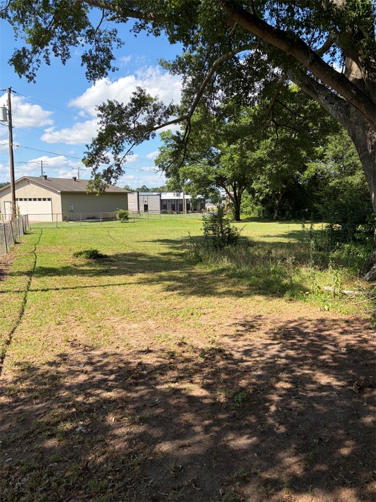 618 Madden Road Jacksonville, AR 72076 - Photo 8 of 34 Expansive lot featuring mature trees and partial chain link fencing
