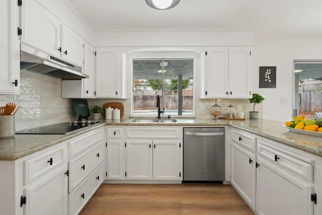 a kitchen with white cabinets and white appliances