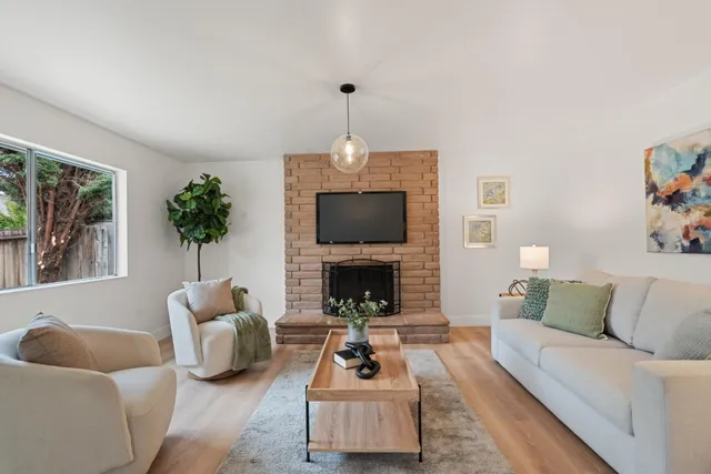 a living room with furniture and a fireplace