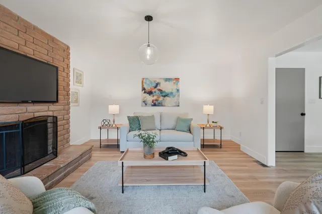 a living room with furniture a fireplace and a flat screen tv